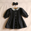 Black polka dot dress with matching hair clip