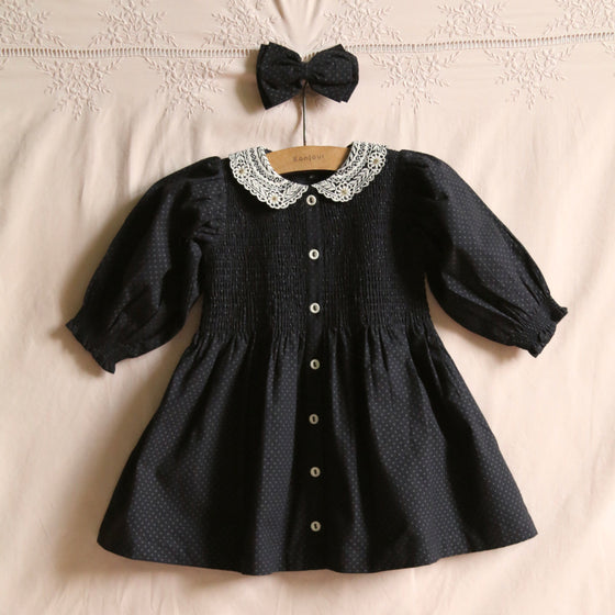 Black polka dot dress with matching hair clip