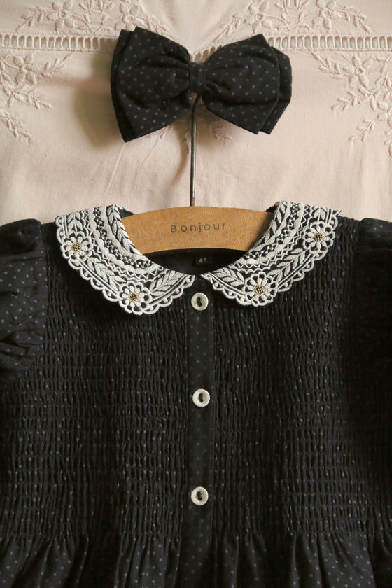 Black polka dot dress with matching hair clip